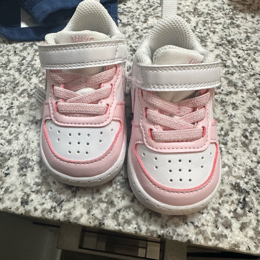 Baby pink and white Nike shoe